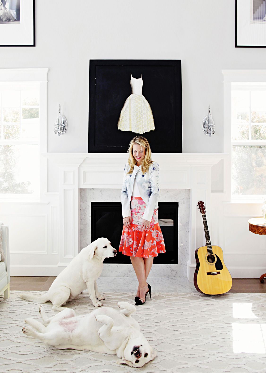 Vibrant environmental portrait by Kimberly Genevieve: A lady radiating joy with her beloved dogs in a living room setting