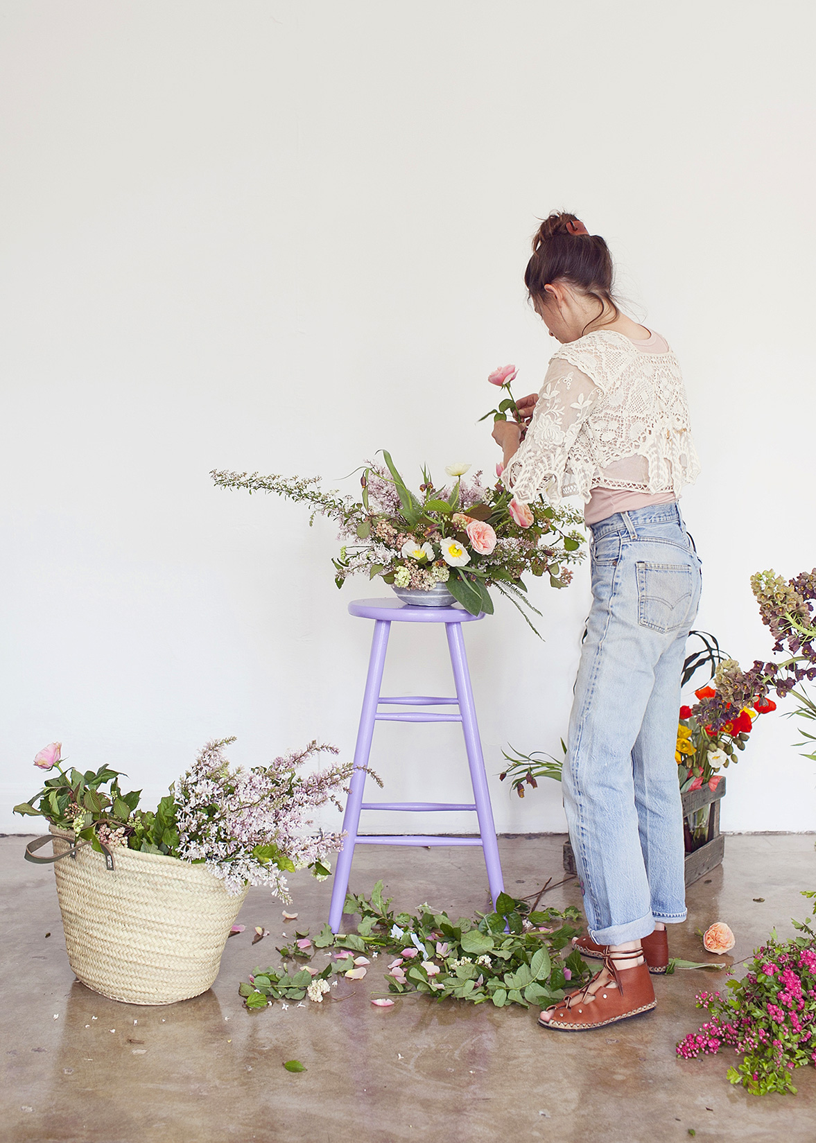 Artful lifestyle moment by Kimberly Genevieve: Woman arranging flowers in Los Angeles